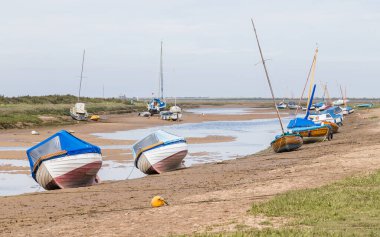 Kuzey Norfolk sahilinde Blakeney 'de kıyıya vuran tekneler Haziran 2021' de sular çekildiğinde görüldü..