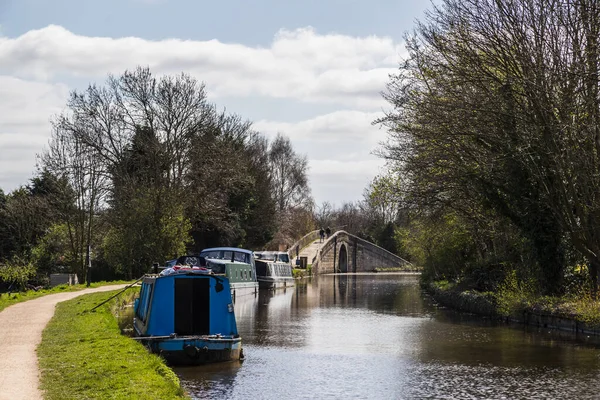 Narrow boats moored along the main stretch of the Leeds Liverpool Canal near Burscough, Lancashire next to the Rufford junction.