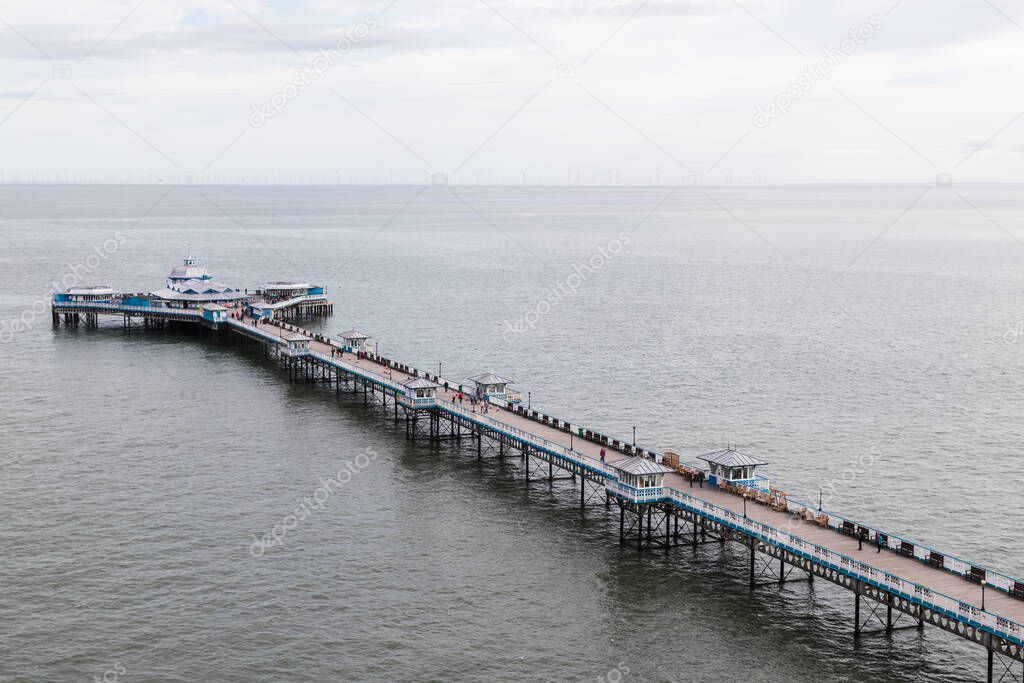 Looking down on Llandudno Pier from the vantage point of the cable car on the way to the Great Orme seen in October 2021 on the North Wales coastline.