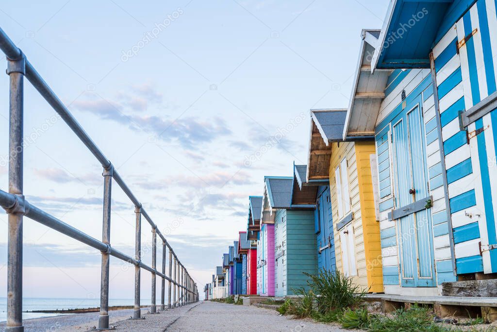 Pretty beach huts lined up on the East beach of Cromer seafront on the North Norfolk coast pictured in June 2021.