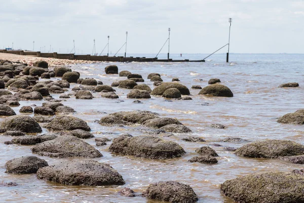 Waves lap up against the rock pools at Hunstanton beach seen in the summer of 2021.