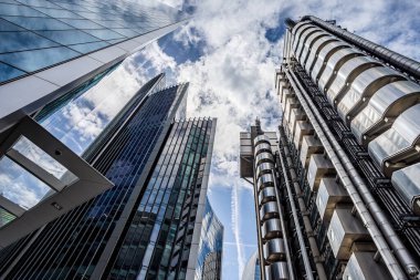 Looking up at the towering Willis Building and Lloyds of London Building in the heart of the Square Mile in London seen in May 2022. clipart