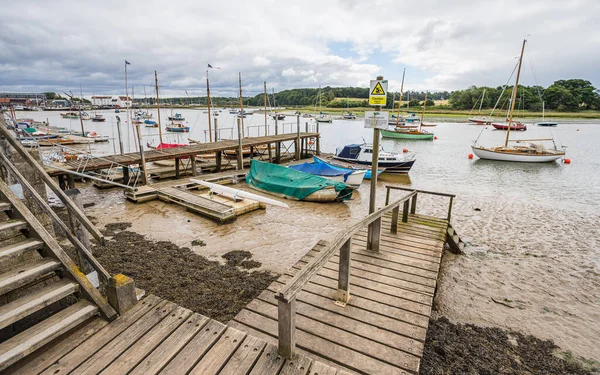 Wooden steps lead down to a jetty at Woodbridge Quay, Suffolk pictured in July 2022.