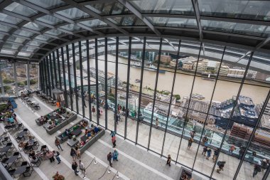 Looking down on tourists on the outside roof terrace of the Sky Garden on top of the Walkie Talkie Building in London seen in August 2022.
