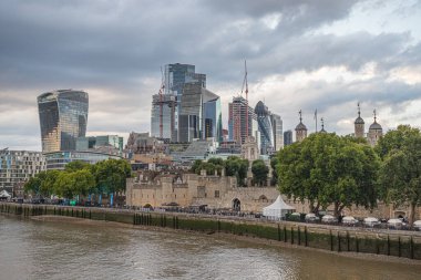 The ever growing skyscrapers in the Square Mile  district of London tower of the Tower of London on the bank of The River Thames seen in July 2022.