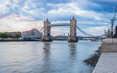 A multi image HDR panorama of Tower Bridge spanning the River Thames in London at dusk in July 2022.