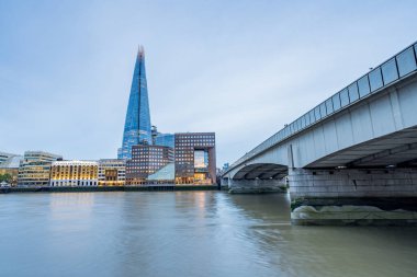 London Bridge leads towards The Shard skyscraper one evening in August 2022 as day gives way to night.