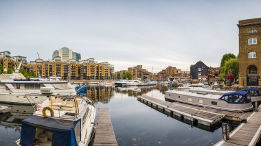 A multi image panorama of boats in St Katharine Docks Marina, seen in August 2022 in the heart of London.