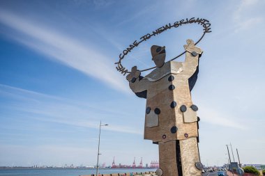 The Welcome to New Brighton statue (created by Joan Ellis in 2001) seen marking the entrance to the seaside town on the Wirral near Liverpool seen in August 2022.