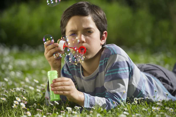 Child playing and blow soap bubbles — Stock Photo, Image