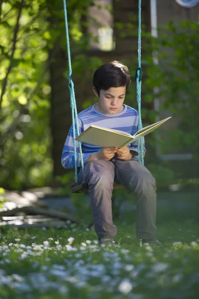 Kind lezen van een boek buitenshuis — Stockfoto