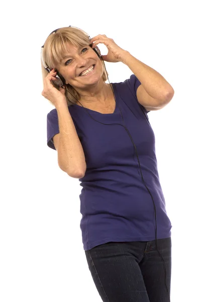 Senior woman 50-60years listening to music with stereo headphone — Stock Photo, Image
