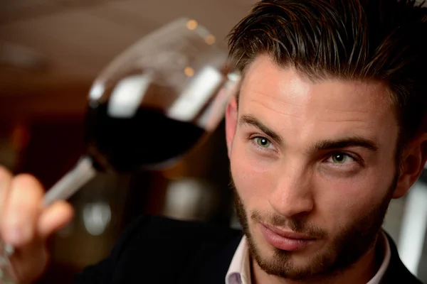 Young man with redwine glasses at celebration or party — Stock Photo, Image