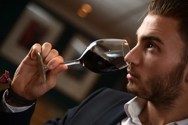 Young man with redwine glasses at celebration or party — Stock Photo, Image