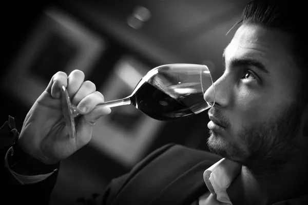 Young man with redwine glasses at celebration or party — Stock Photo, Image