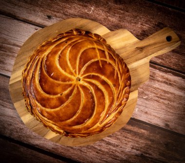 Galette des rois on wooden table, Traditional Epiphany cake in France