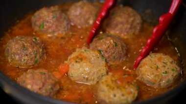 Tavada domates soslu köfte pişirmek. 