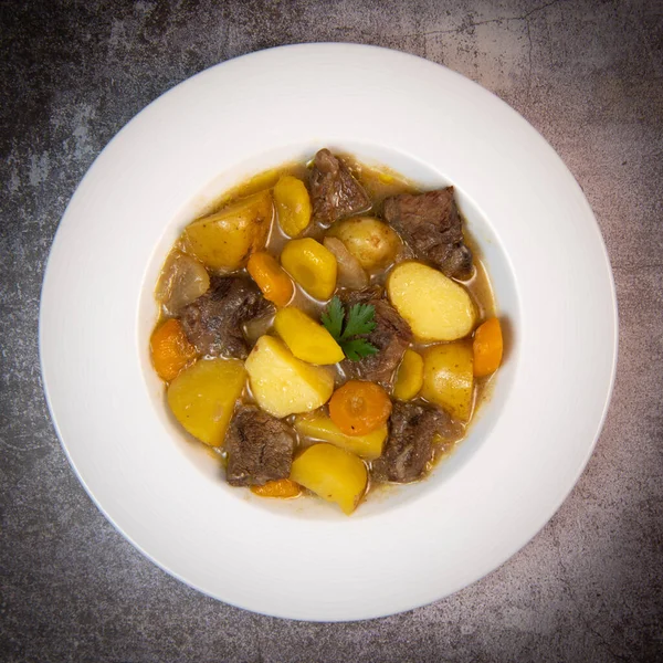 Recipe for beer and mustard beef chuck stew with potatoes, turnips and carrots, High quality photo