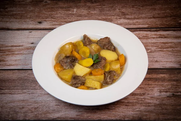 Recipe for beer and mustard beef chuck stew with potatoes, turnips and carrots, High quality photo