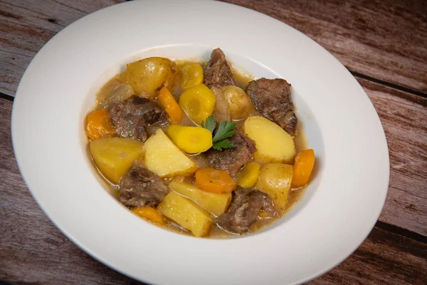 Recipe for beer and mustard beef chuck stew with potatoes, turnips and carrots, High quality photo