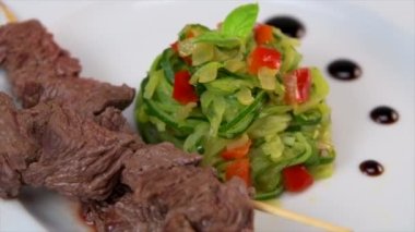 Skewer of beef mitre with curgettes and red pepper tagliatelle recipe. High quality video