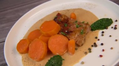 Recipe for baked lamb shoulder with watercress mashed, sweet potato and carrot, pepper sauce, cognac and fresh cream. High quality video