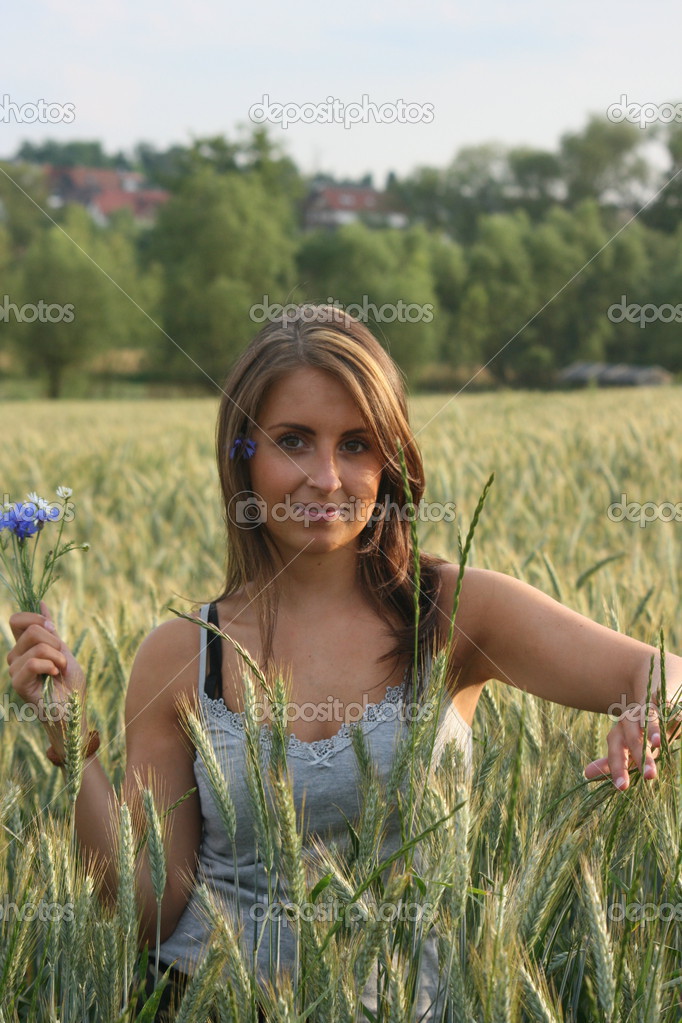 Woman in a wheat field on a summer evening