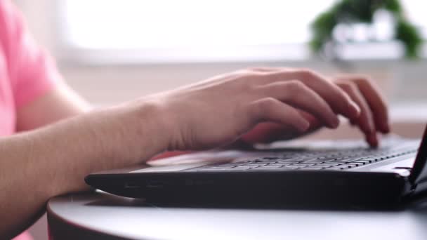 Händerna på en man som arbetar på en bärbar dator, kamera spårning, närbild — Stockvideo