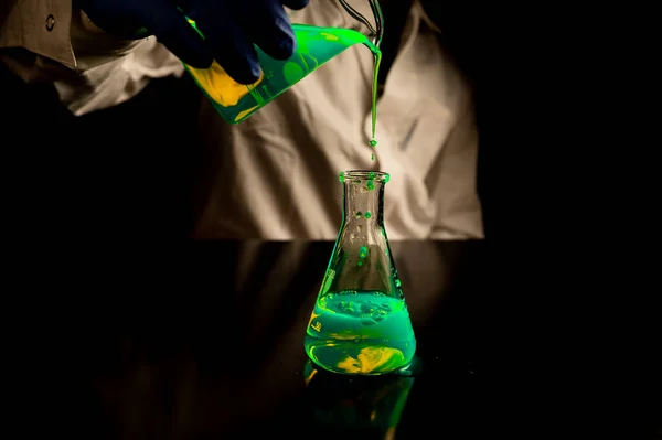 Woman Scientist Experimenting Green Fluorescent Solution Glass Conical Flask Dark —  Fotos de Stock