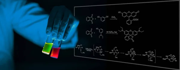 A woman scientist holding Organic chemistry sample glass vials in a laboratory - radioactive - fluorescence. A copy space black background. Organic medicinal chemistry laboratory.