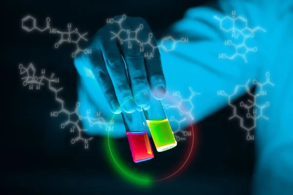 Organic sample glass vials hold by a woman scientist in a laboratory - radioactive - fluorescence. A copy space black background. Organic medicinal chemistry laboratory.