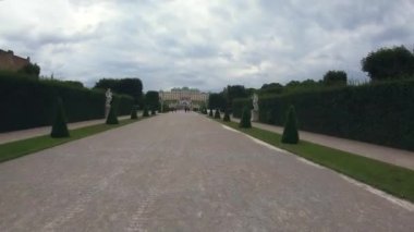 4K timelapse of Schonbrunn palace with beautiful floral garden timelapse, Vienna Austria. Blue sky with clouds on sunny day. Green lawn and historic buildings.