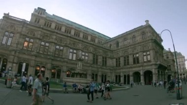 Vienna, Austria - June 6, 2022. 4K slowmotion of Opera house, Vienna Austria. Blue sky with clouds on sunny day. Evening and historic buildings.
