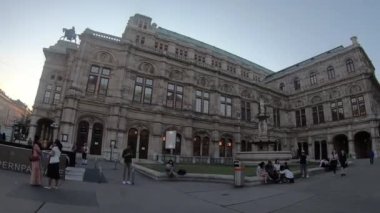Vienna, Austria - June 6, 2022. 4K slowmotion of Opera house, Vienna Austria. Blue sky with clouds on sunny day. Evening and historic buildings.