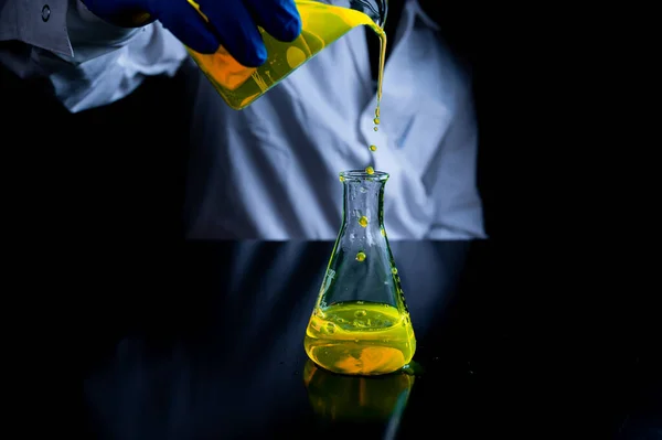 Una Mujer Científica Experimentando Con Una Solución Fluorescente Amarilla Frasco —  Fotos de Stock