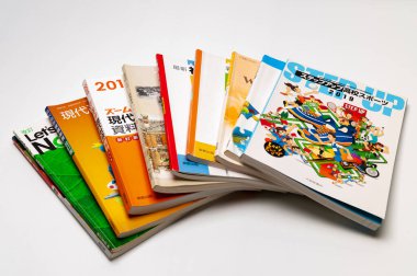 Fuji-Shi, Shizuoka-Ken, Japan - August 9, 2022: Stacked Japanese school books. Isolated on white background	