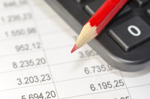 Calculator and red pen — Stock Photo, Image