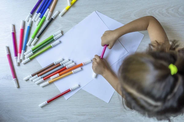 top view of girl drawing on the floor