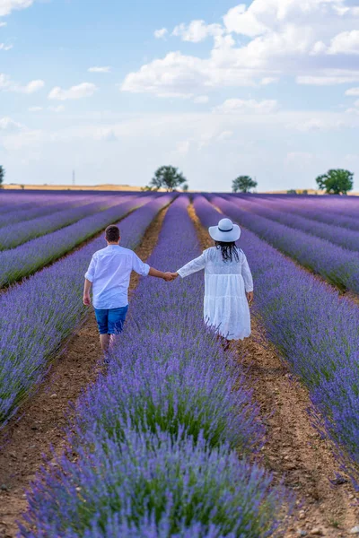 Couple Holding Hands Strolling Lavender Field —  Fotos de Stock