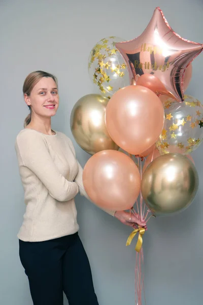 Girl with bundle of purple balloons, girl\'s birthday