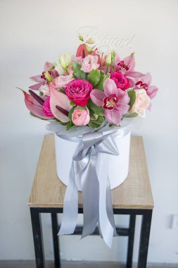 Beyaz şapka kutusunda bir buket çiçek.