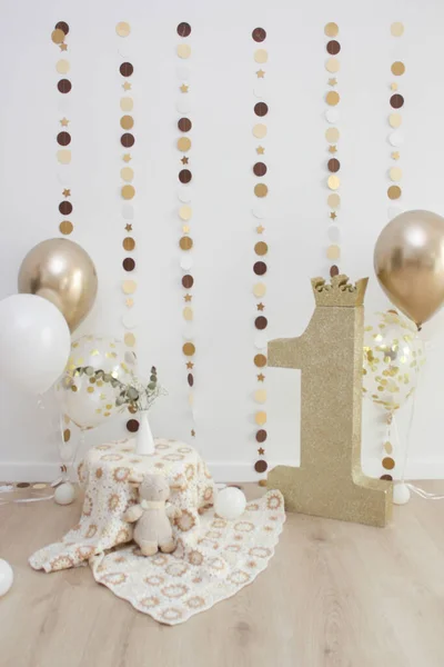 Golden photo zone with balloons, garlands and a number for 1 year