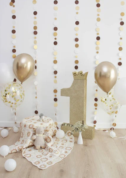 Golden photo zone with balloons, garlands and a number for 1 year