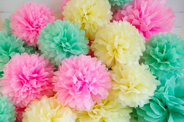 paper flowers for holiday decor. Paper pom-poms - pink, yellow and mint.