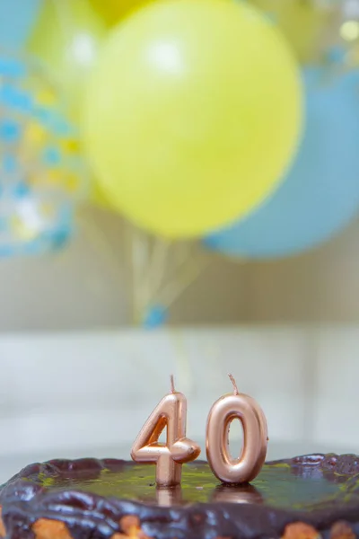 yellow and blue balloons, cake with 40 candles