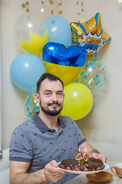 man with balloons and gift