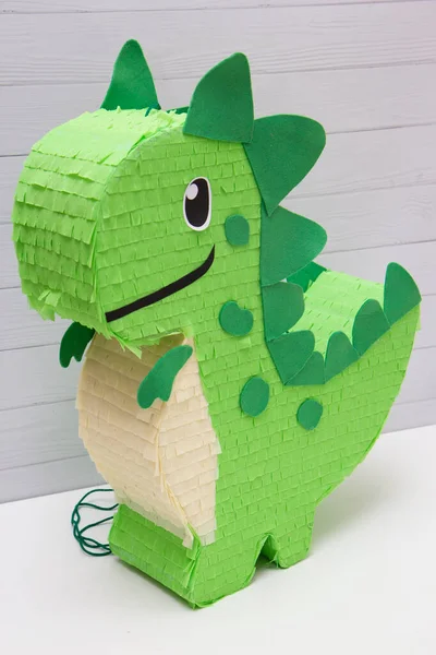 pinata toy green dinosaur on a white background