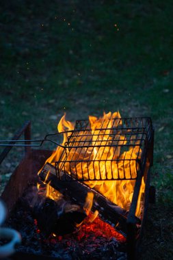 cooking camp on grill at summer time at sunset.