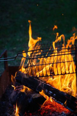 cooking camp on grill at summer time at sunset.