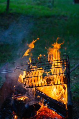 cooking camp on grill at summer time at sunset.